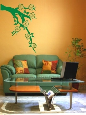 Naklejka ścienna nad kanapą w salonie - gałązka z kwiatami